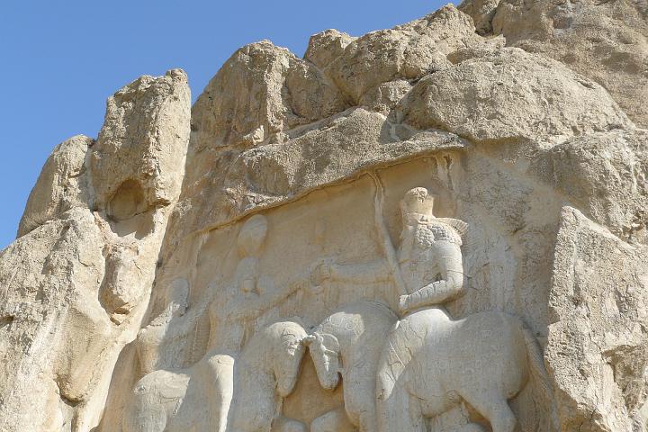 P1000940.JPG - Naqsh-e Rostam, Ardeshir’s investiture. 2 horsemen. On the left Ardeshir, the first Sasanian king. On the right Hormuzd, he god of light who hands to Ardeshir the wreath of victory and power.